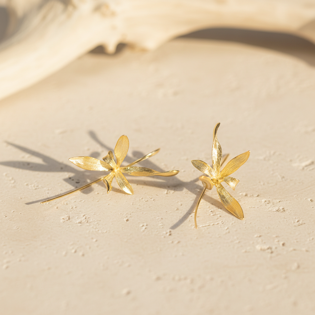 gold earrings with driftwood warm stone background