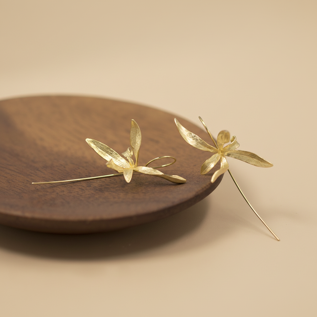 gold earrings wooden tray flat lay