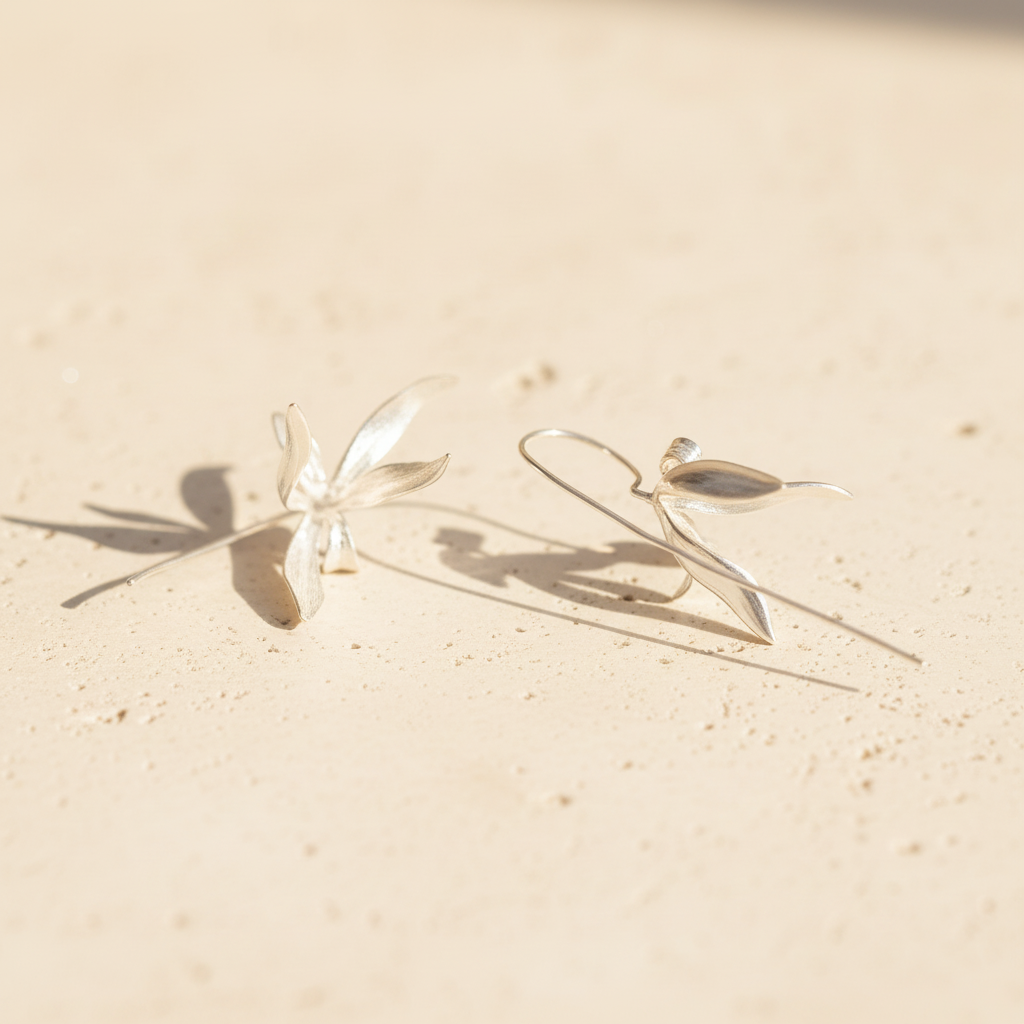 silver earrings warm stone flat lay