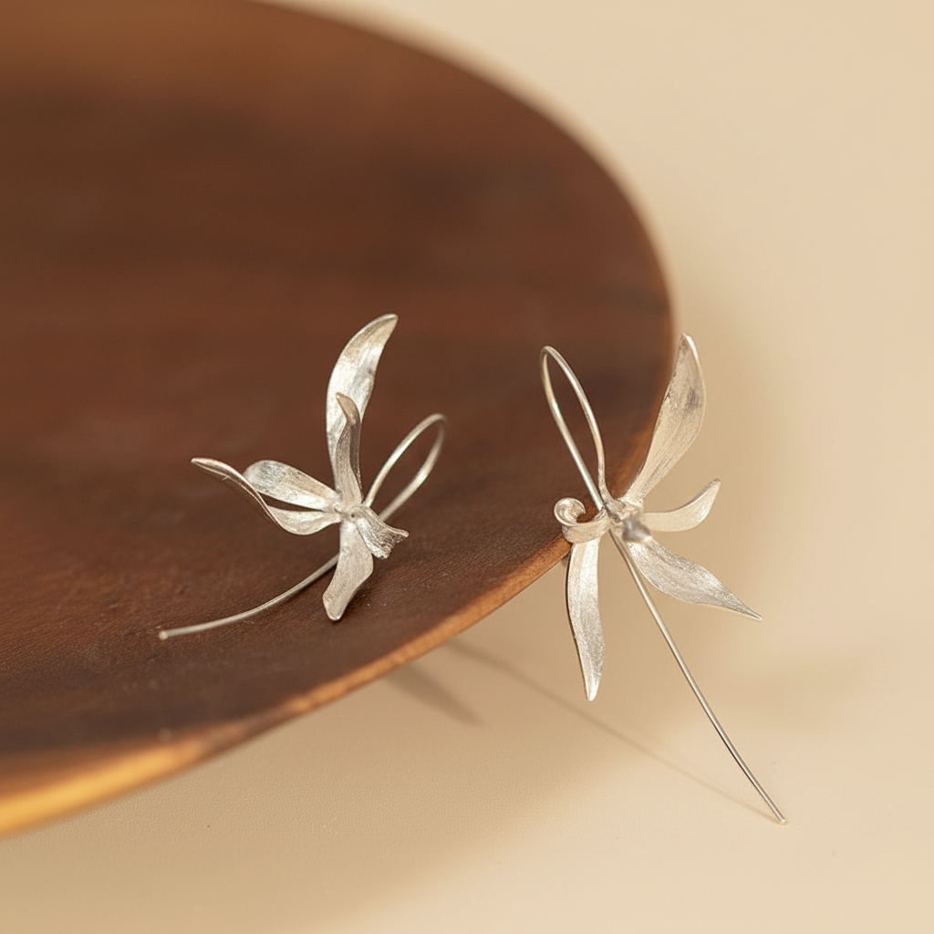 silver earrings wooden tray warm background